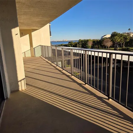 a view of a patio with table and chairs a barbeque with wooden floor and fence