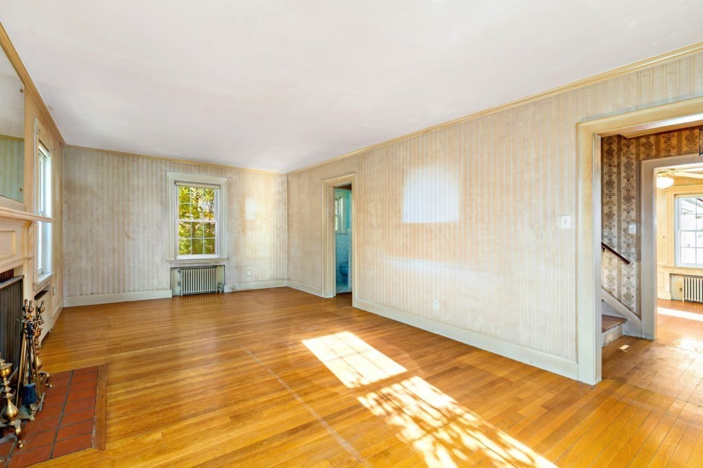 45 Chesterfield Road Milton, MA 02186 - Photo 6 of 23 a view of an empty room with window and a fireplace