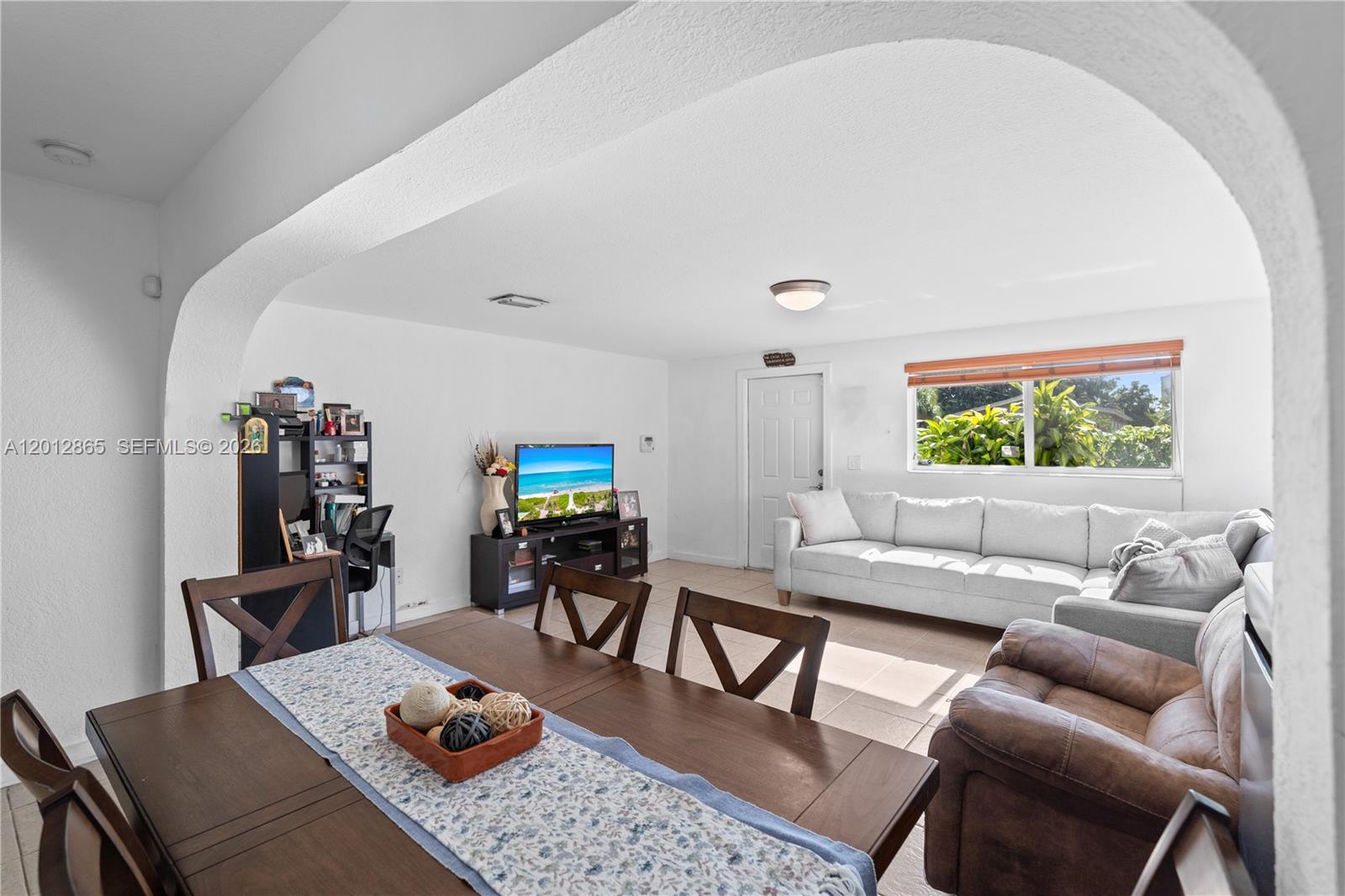 5300 Northwest 30th Place Miami, FL 33142 - Photo 12 of 35 a living room with furniture and a flat screen tv