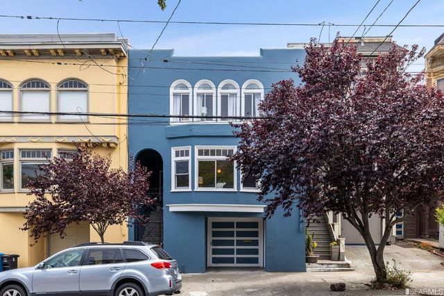 a front view of a house with a garden