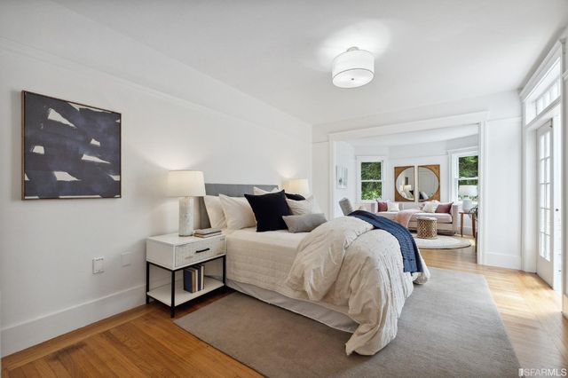 a bed room with a bed and potted plant