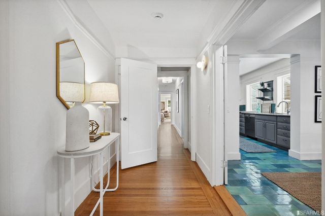 a view of an entryway with wooden floor and a bathroom