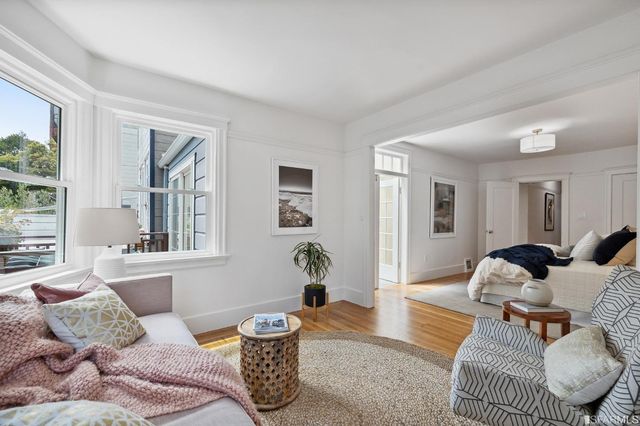 a living room with furniture chess table and a window