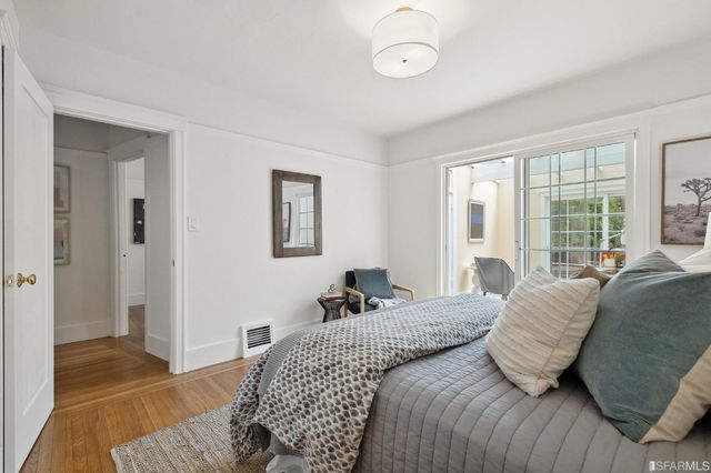 a bedroom with a bed and glass window