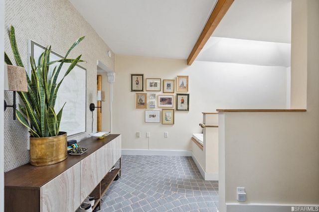 a living room with furniture and a potted plant