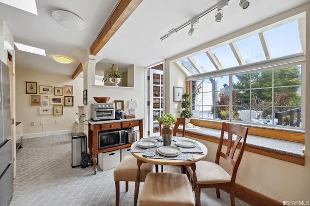 a view of a patio with couches and a potted plant on a table