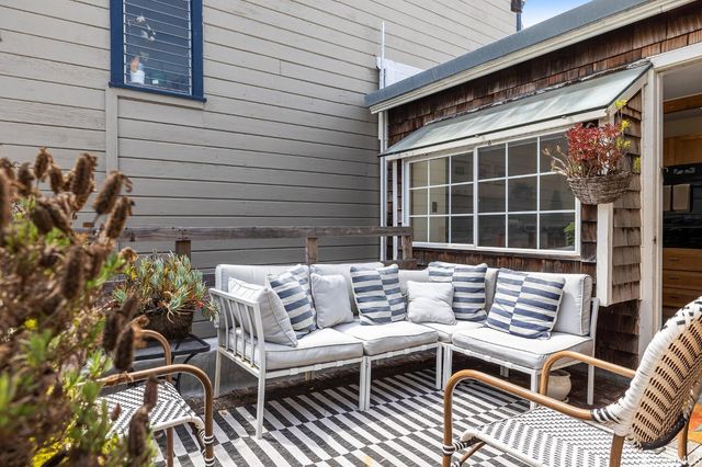 a living room with a fireplace and a painting on the wall