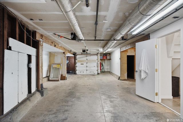 a view of a patio with table and chairs and wooden fence