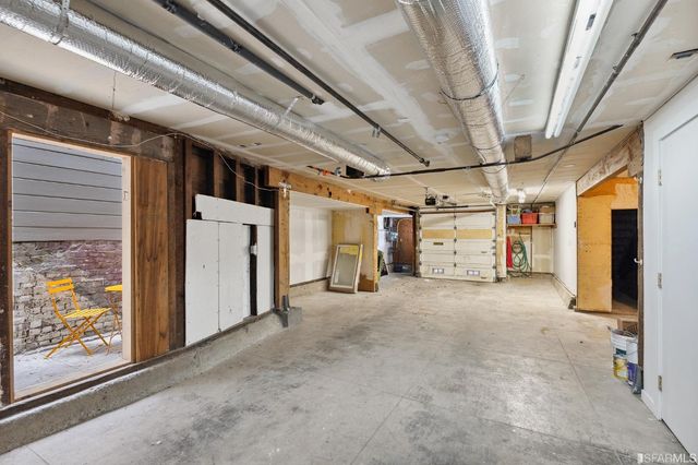 a living room with furniture a potted plant and a table