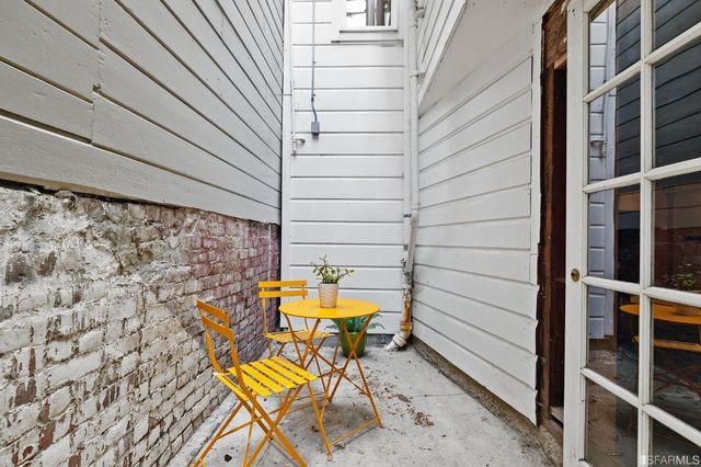 a view of deck with table and chairs and wooden floor