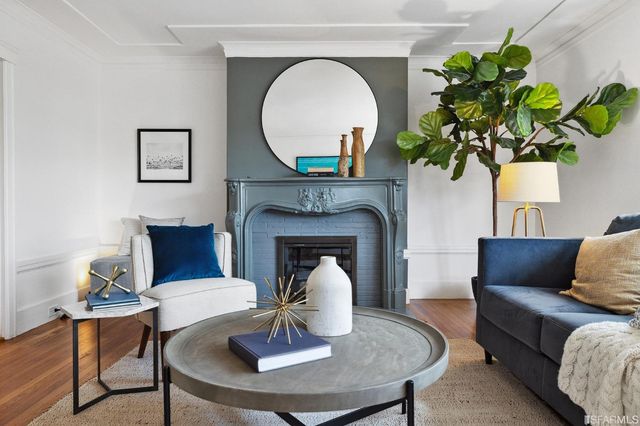 a living room with furniture and a fireplace