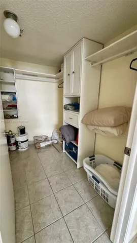 a view of a storage & utility room with two washing machine
