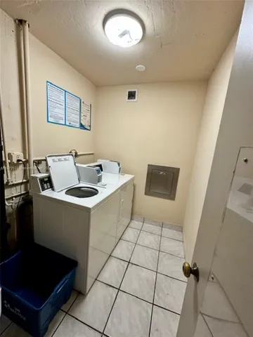 a view of swimming pool with a table and chairs under an umbrella