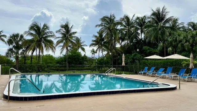 a lobby with furniture and lots of glass windows