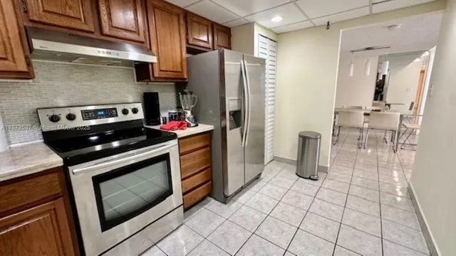 a kitchen with appliances cabinets and a stove