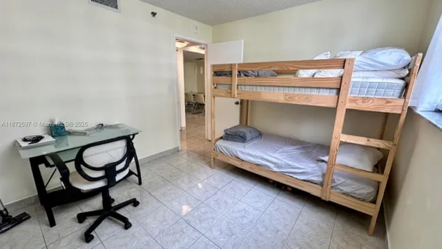 a bedroom with a bunk bed and a dresser in it