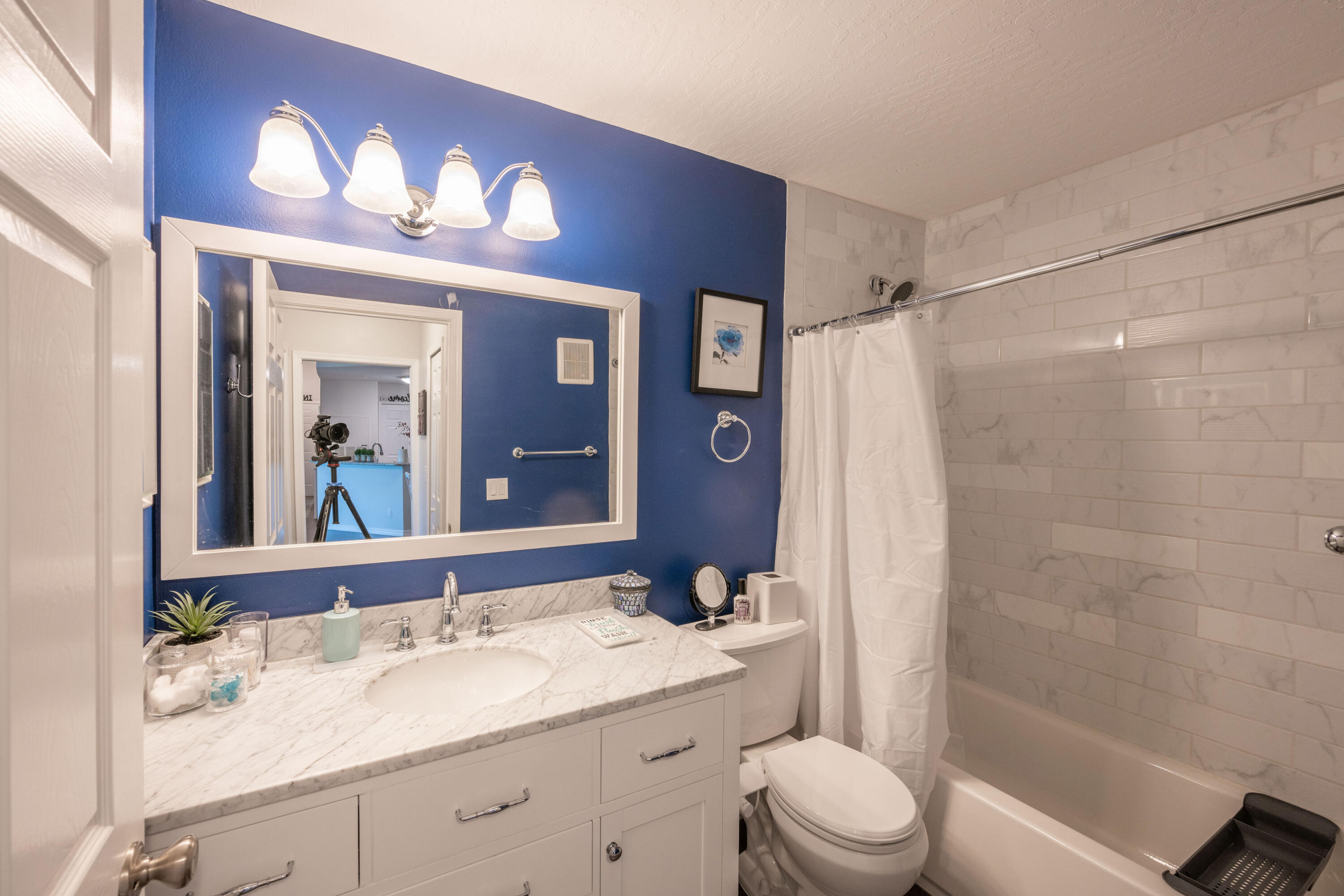 7667 North Wickham Road, Unit 1518 Melbourne, FL 32940 - Photo 11 of 32 a bathroom with a sink a toilet a large mirror and shower
