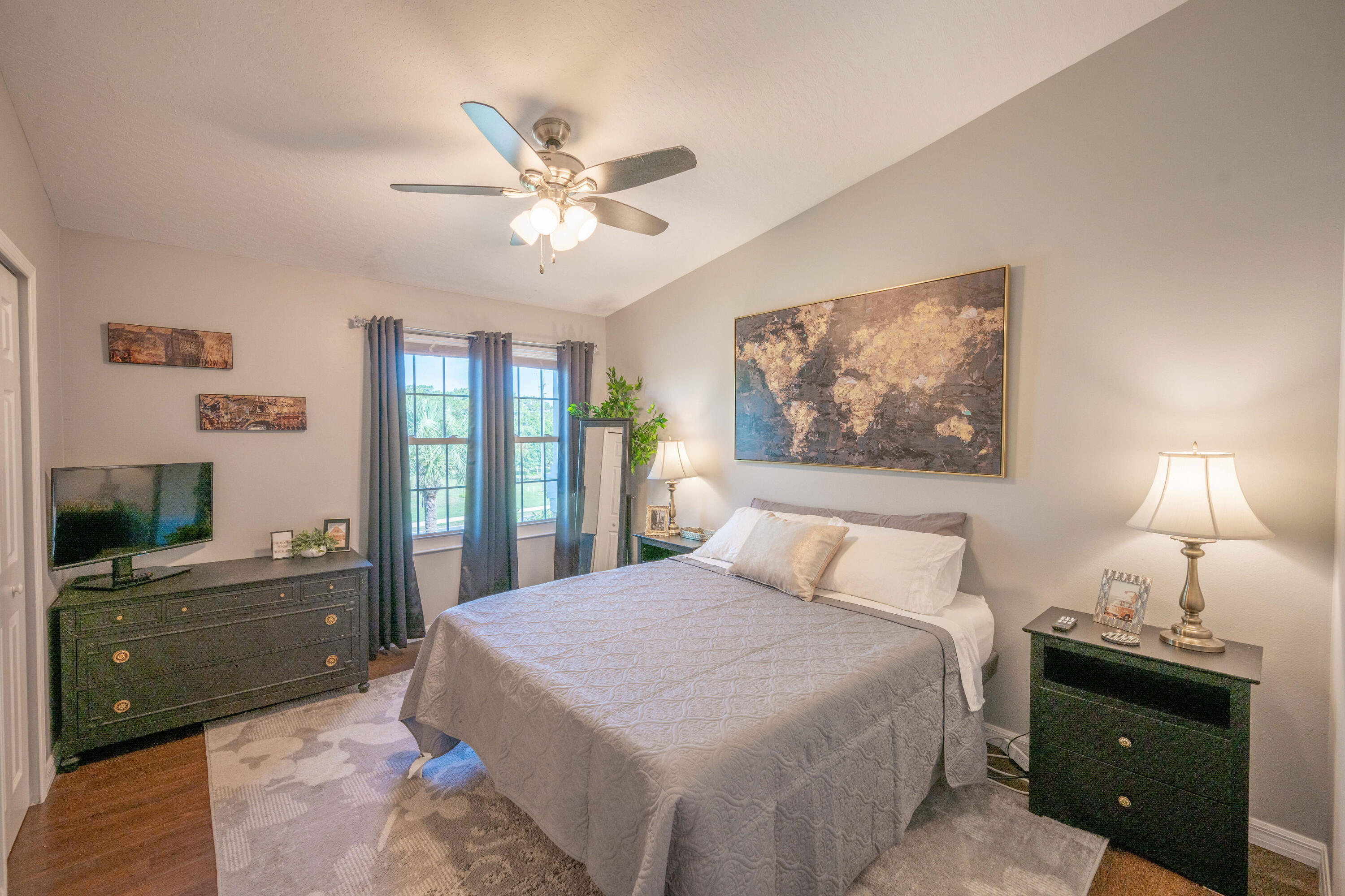 7667 North Wickham Road, Unit 1518 Melbourne, FL 32940 - Photo 12 of 32 a bedroom with a bed and a chandelier