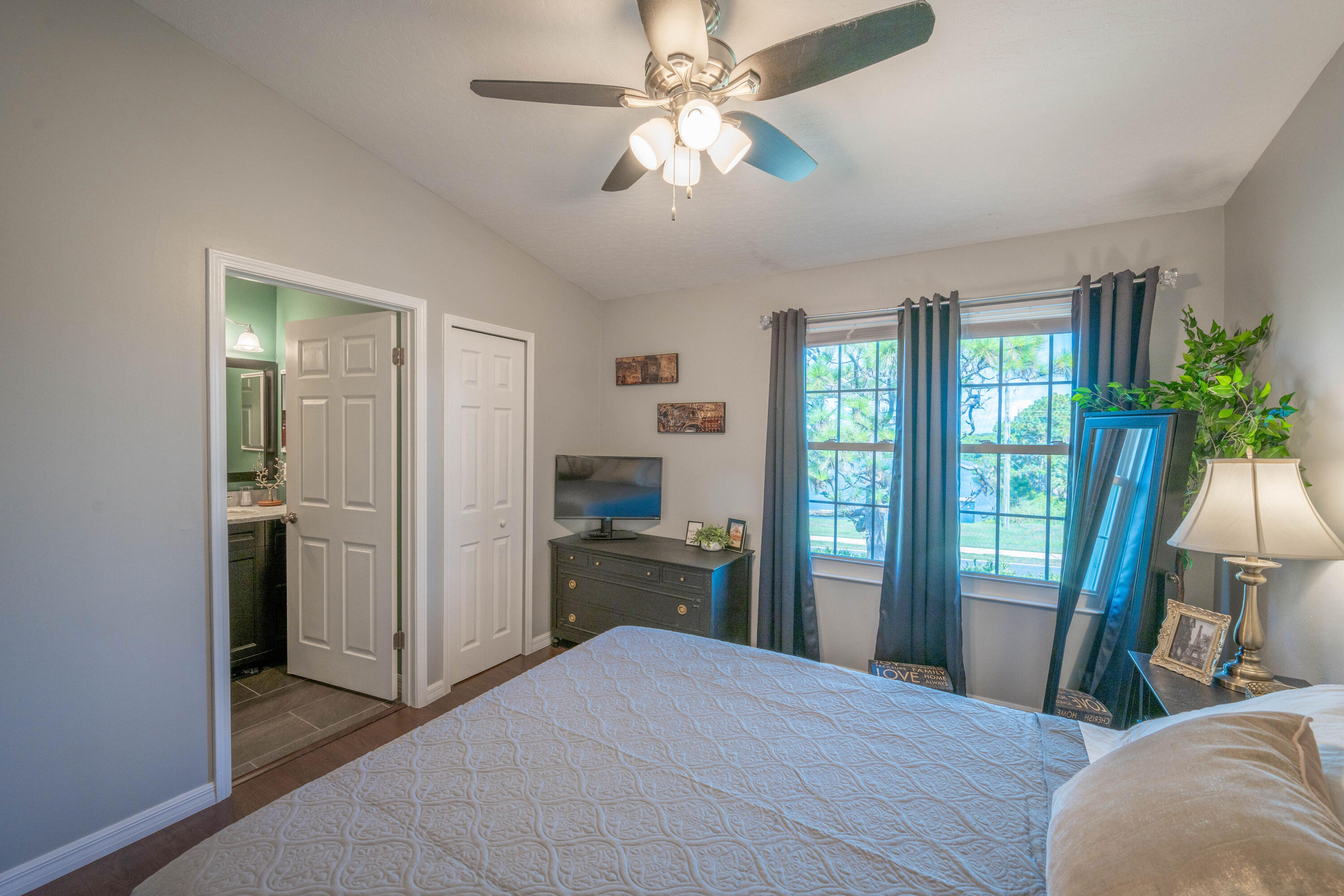 7667 North Wickham Road, Unit 1518 Melbourne, FL 32940 - Photo 13 of 32 a bedroom with a bed and a chandelier
