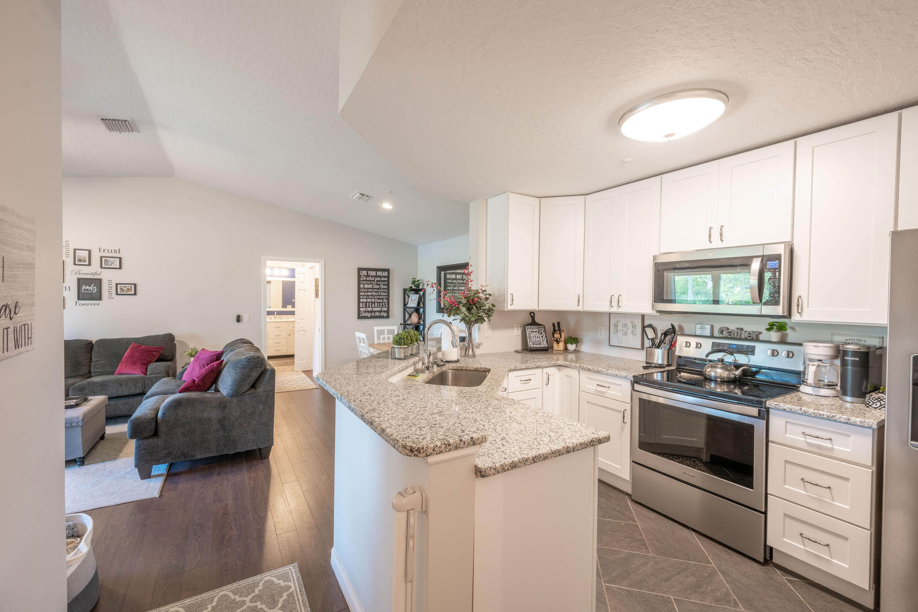7667 North Wickham Road, Unit 1518 Melbourne, FL 32940 - Photo 2 of 32 a kitchen with a sink stove and cabinets