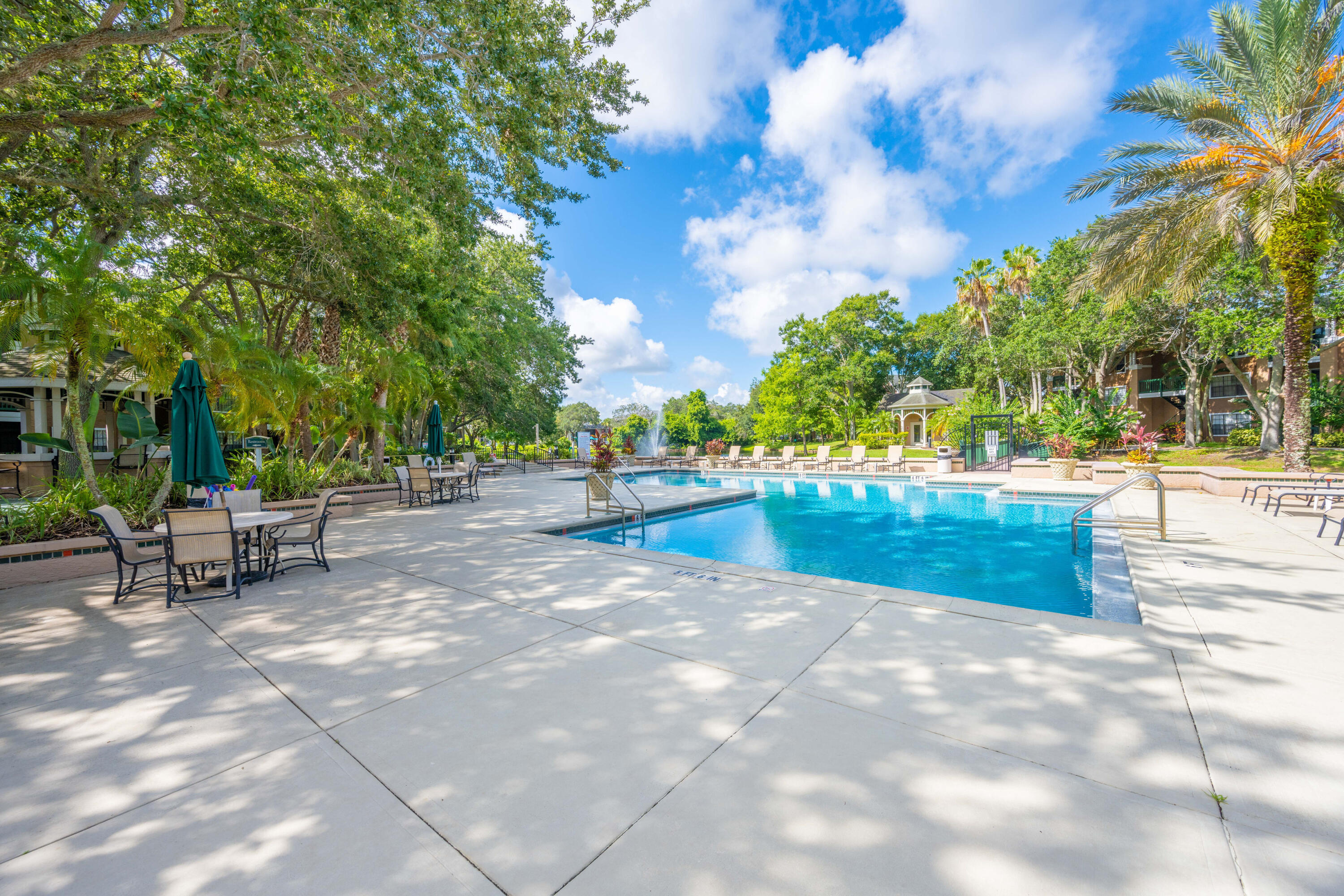 7667 North Wickham Road, Unit 1518 Melbourne, FL 32940 - Photo 24 of 32 a view of swimming pool with outdoor seating and trees