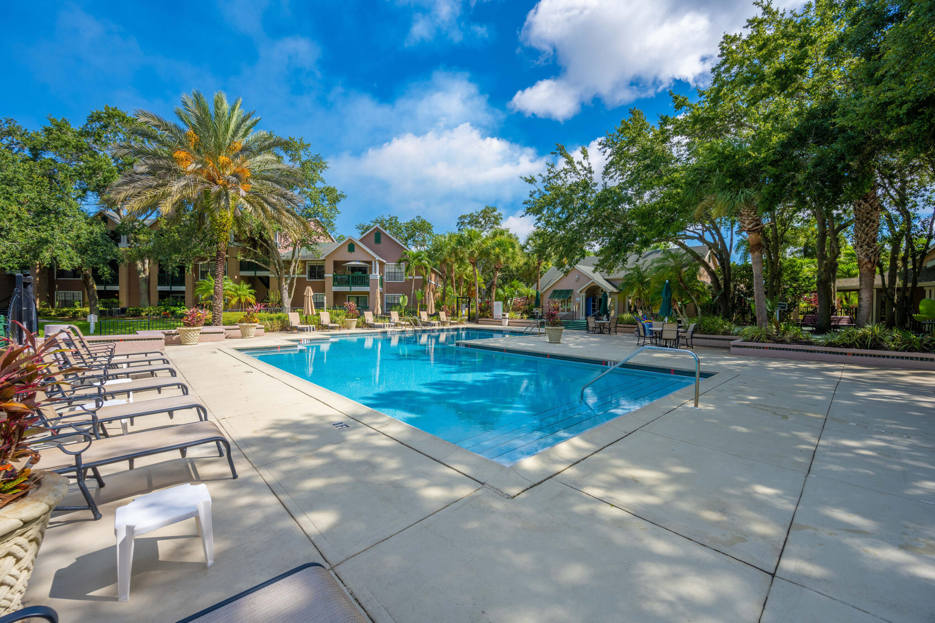 7667 North Wickham Road, Unit 1518 Melbourne, FL 32940 - Photo 25 of 32 a view of a swimming pool with an outdoor seating and a pathway
