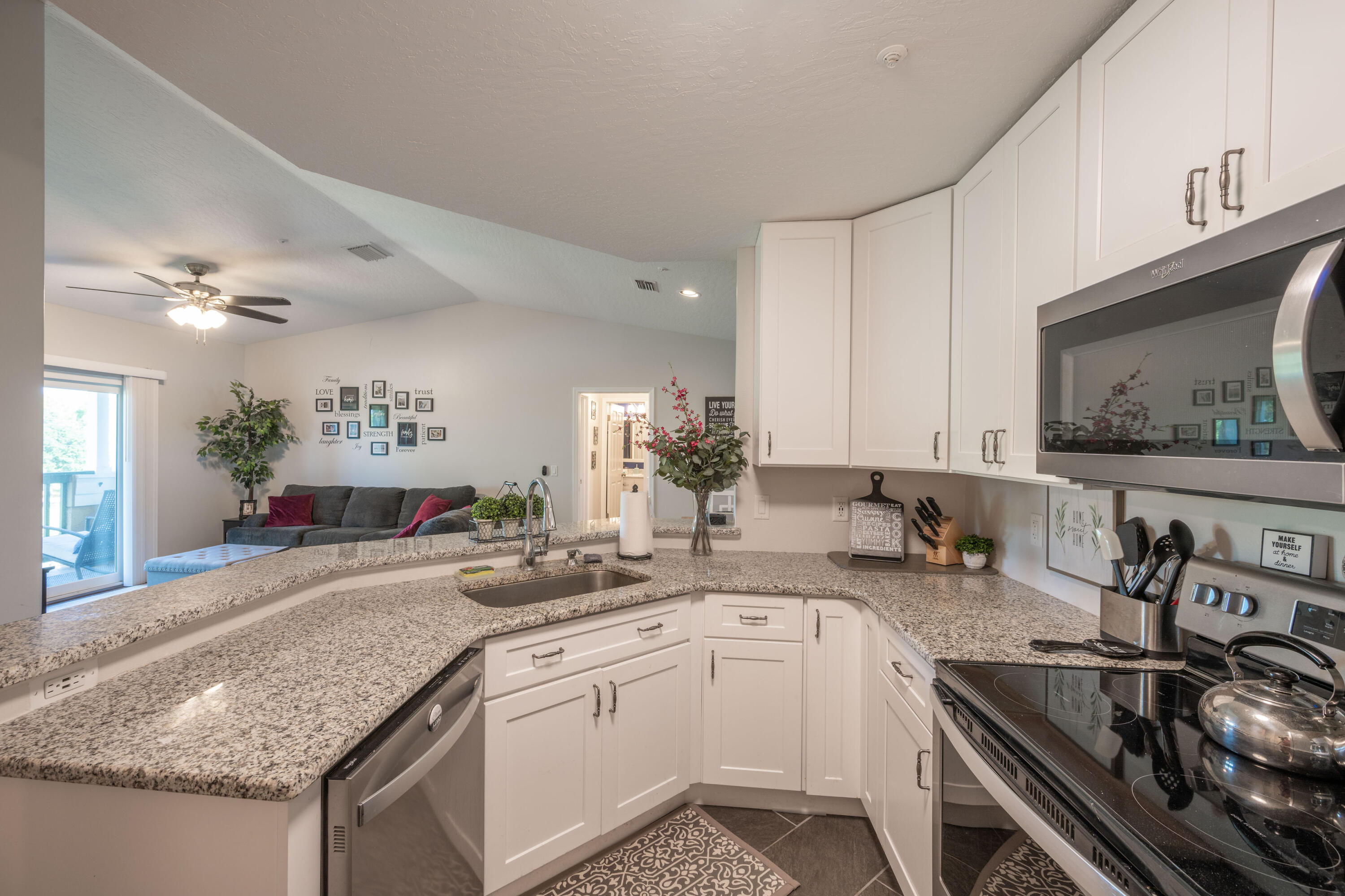 7667 North Wickham Road, Unit 1518 Melbourne, FL 32940 - Photo 4 of 32 a kitchen with a sink and a stove top oven