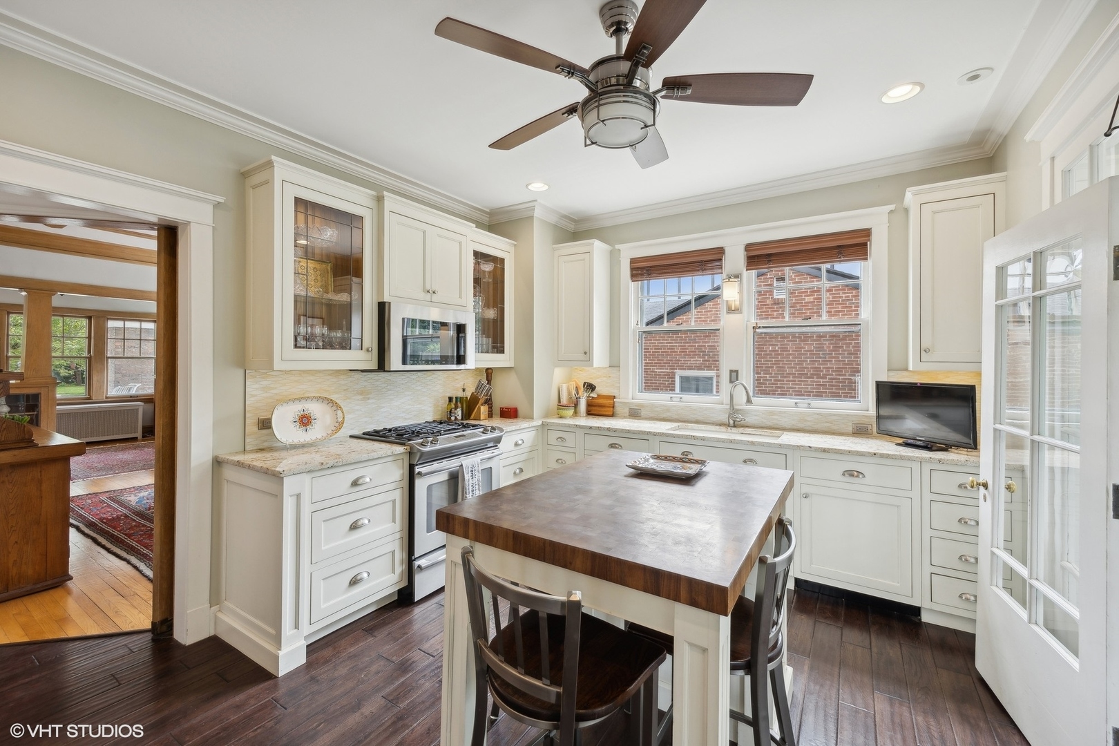 208 Woodside Road Riverside, IL 60546 - Photo 17 of 37 a open kitchen with stainless steel appliances granite countertop a stove a sink dishwasher a dining table and chairs with wooden floor
