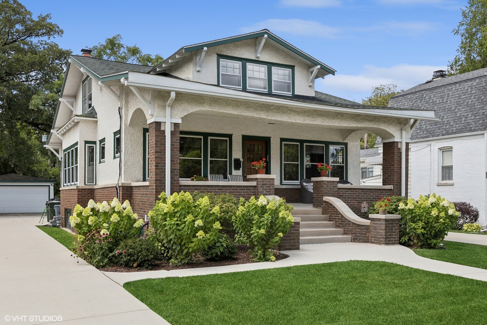 208 Woodside Road Riverside, IL 60546 - Photo 2 of 37 a front view of a house with a garden and plants