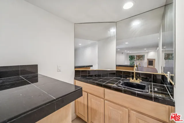 a kitchen with stainless steel appliances a refrigerator and a stove