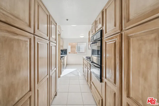 a kitchen with a stove a sink and a microwave