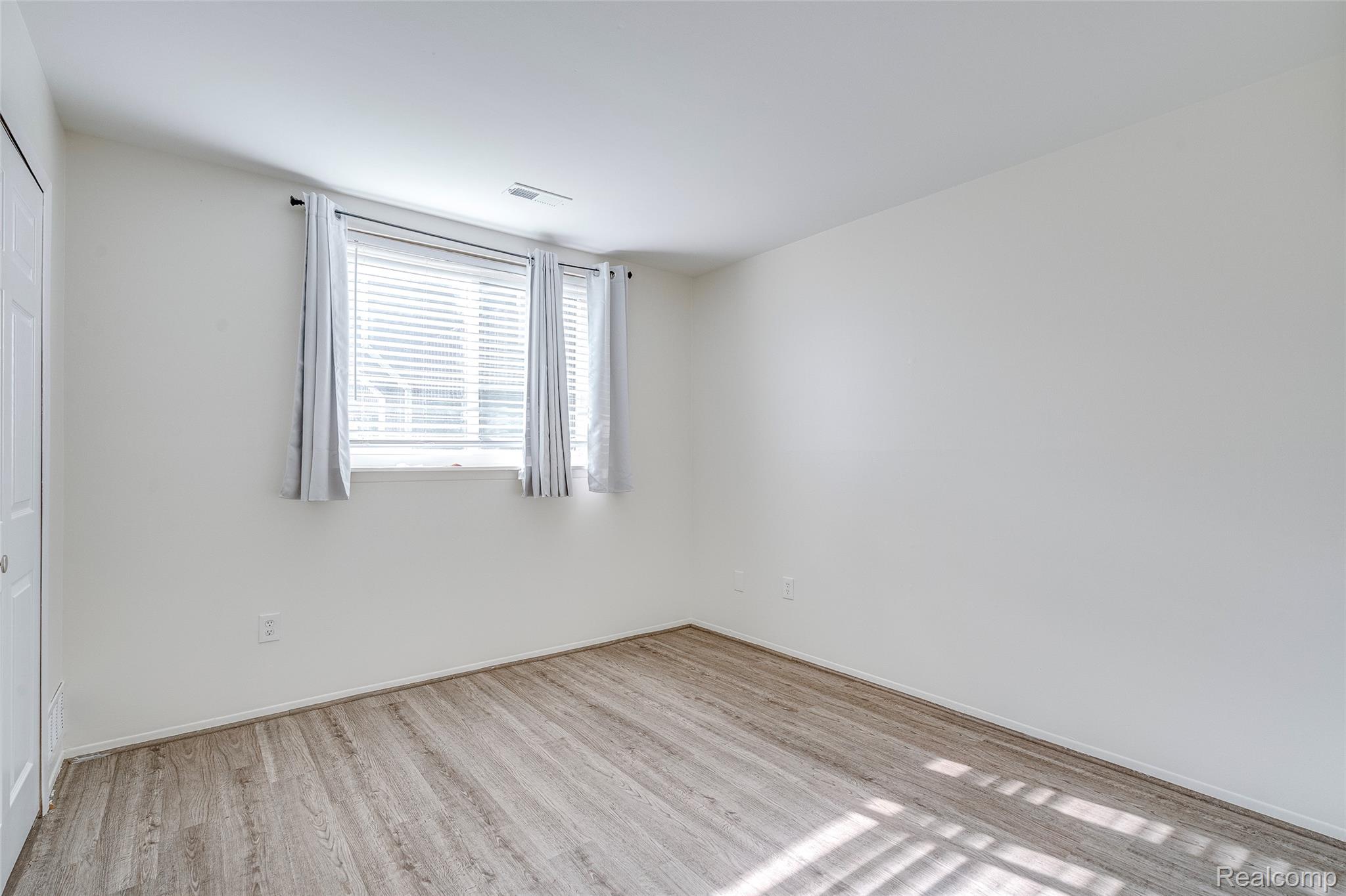 29860 West 12 Mile Road, Unit 604 Farmington, MI 48334 - Photo 19 of 26 Unfurnished room featuring light wood-style flooring and baseboards