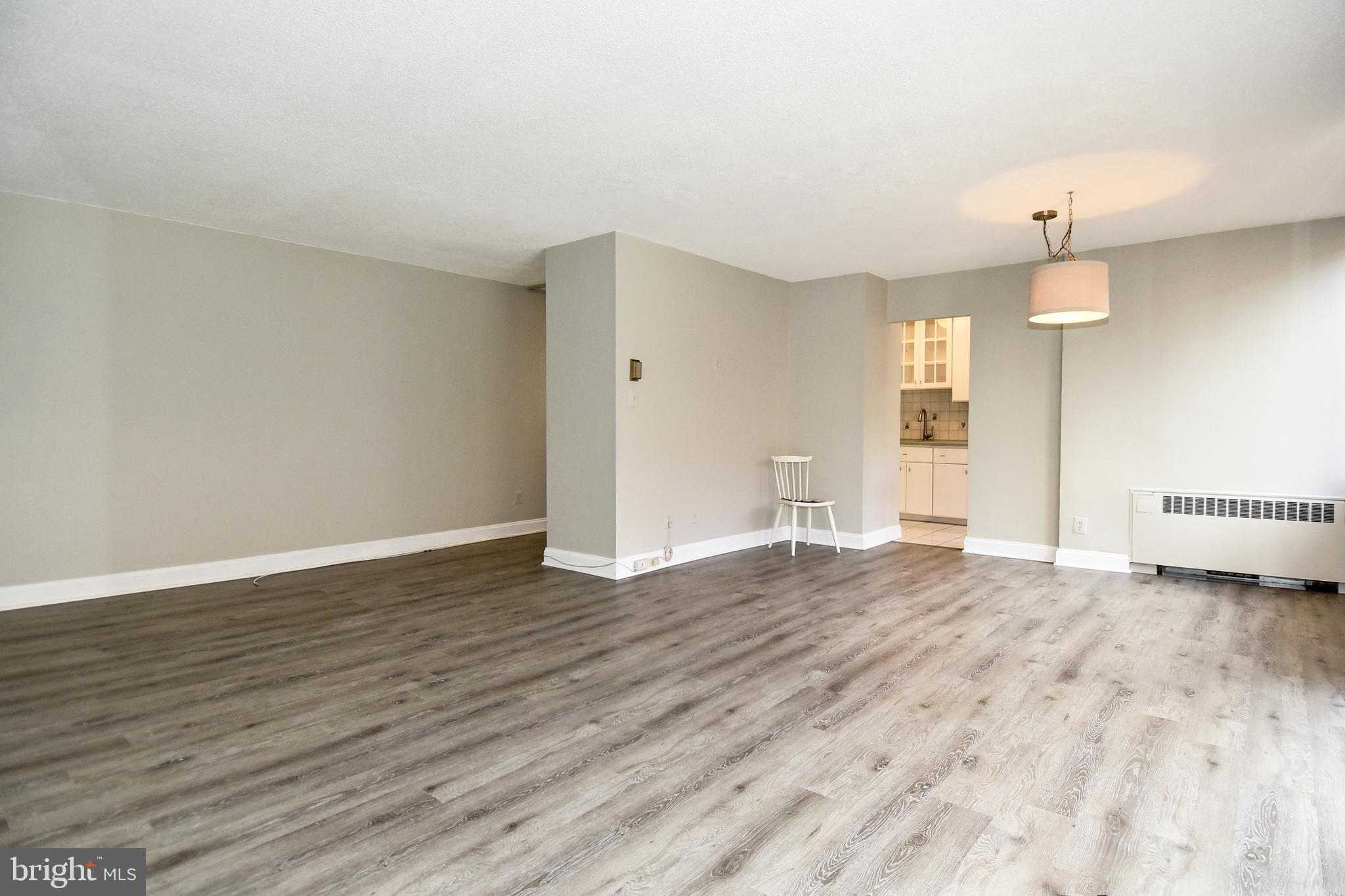 1301 South Arlington Ridge Road, Unit 110 Arlington, VA 22202 - Photo 2 of 45 a view of an empty room with wooden floor and a window