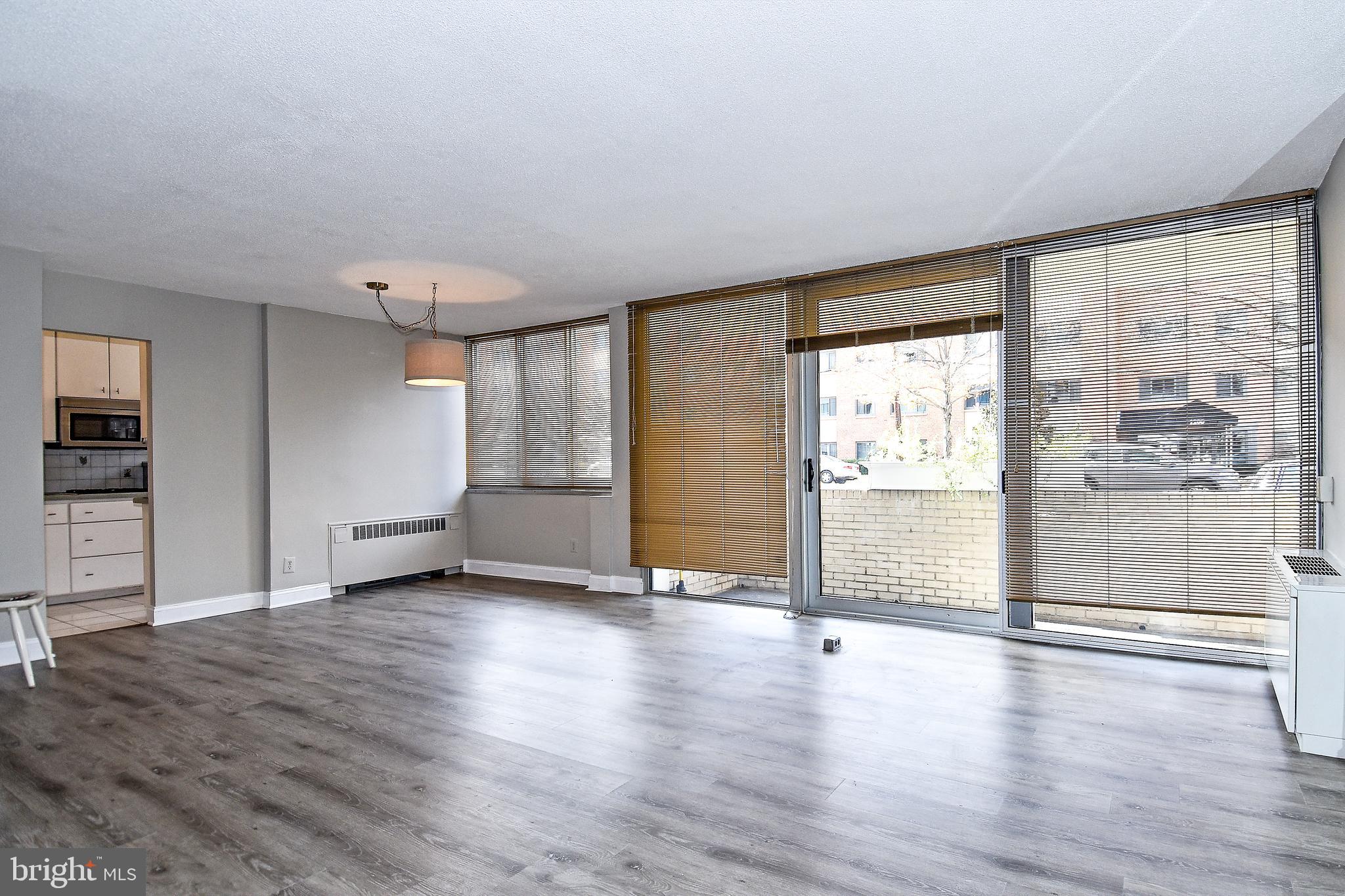 1301 South Arlington Ridge Road, Unit 110 Arlington, VA 22202 - Photo 11 of 45 an empty room with wooden floor and windows