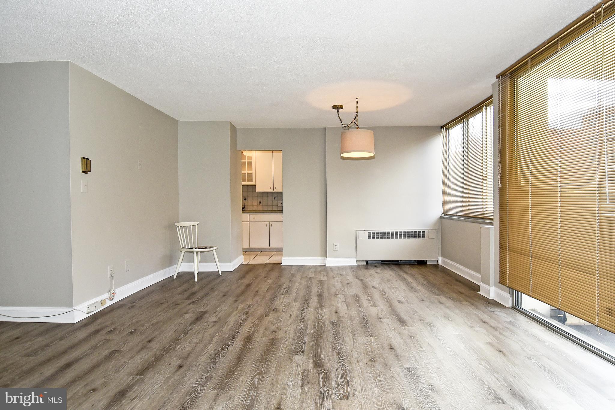 1301 South Arlington Ridge Road, Unit 110 Arlington, VA 22202 - Photo 12 of 45 an empty room with wooden floor and windows