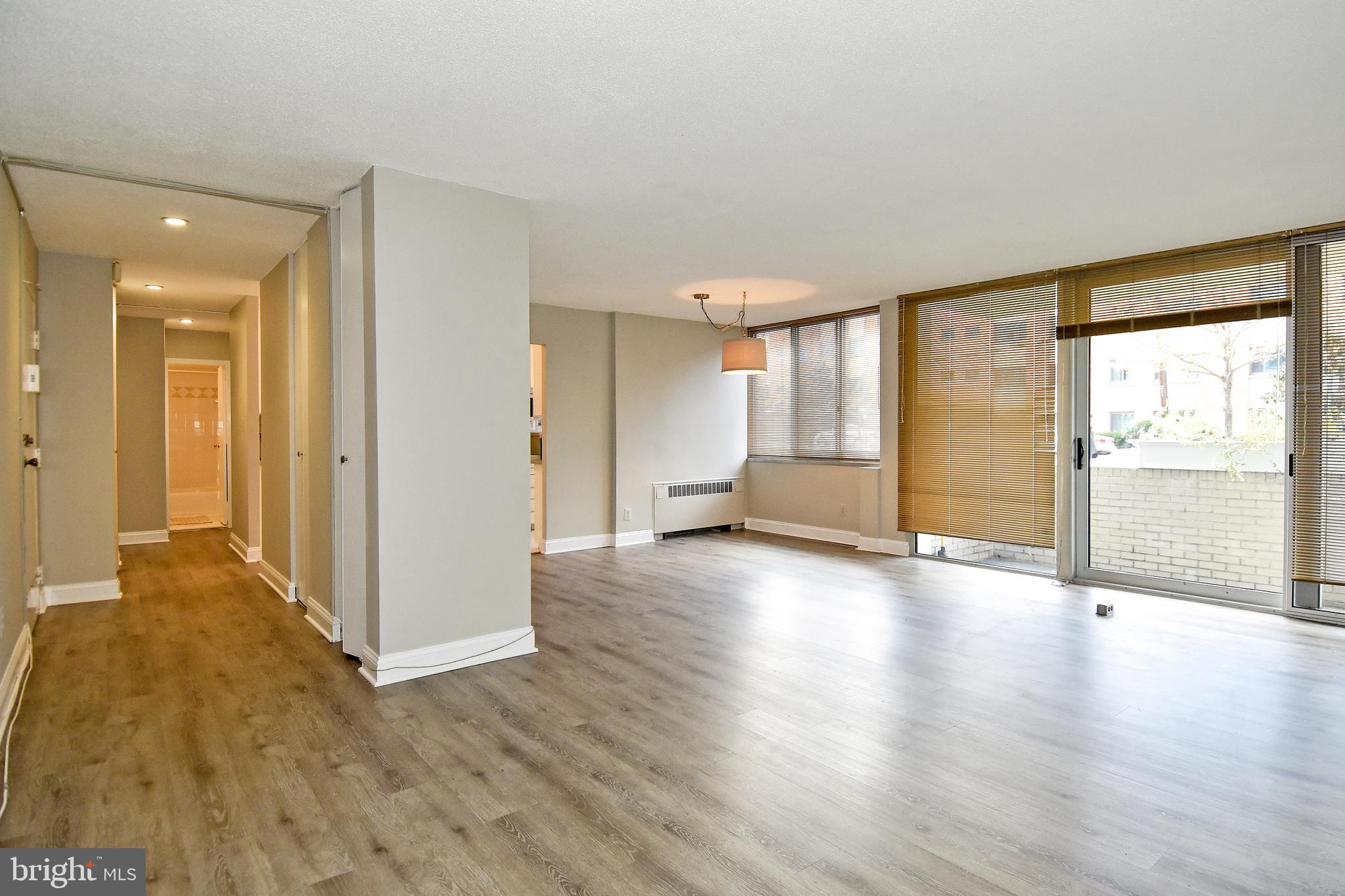 1301 South Arlington Ridge Road, Unit 110 Arlington, VA 22202 - Photo 13 of 45 an empty room with wooden floor and windows