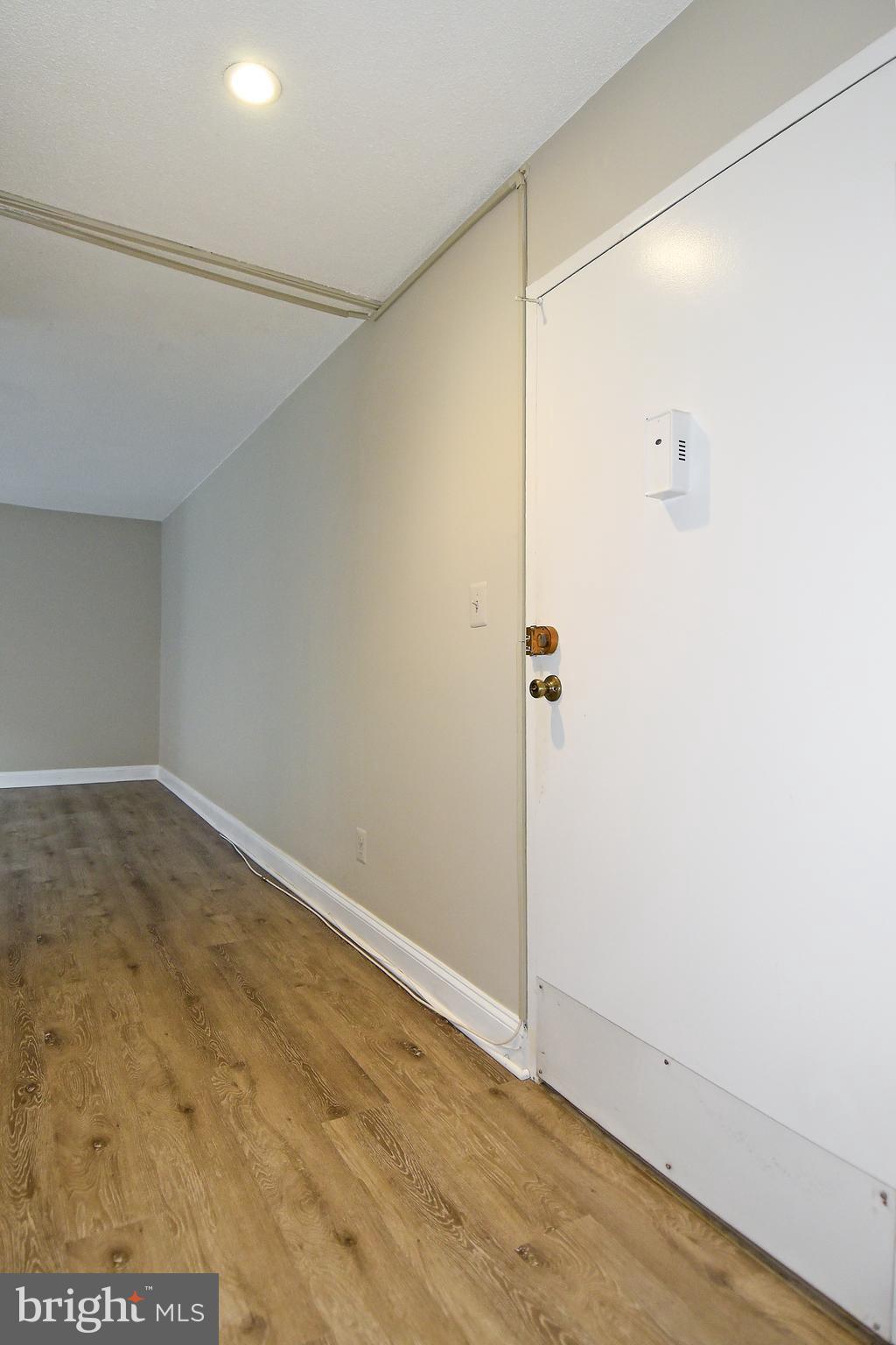 1301 South Arlington Ridge Road, Unit 110 Arlington, VA 22202 - Photo 14 of 45 an empty room with wooden floor and shower