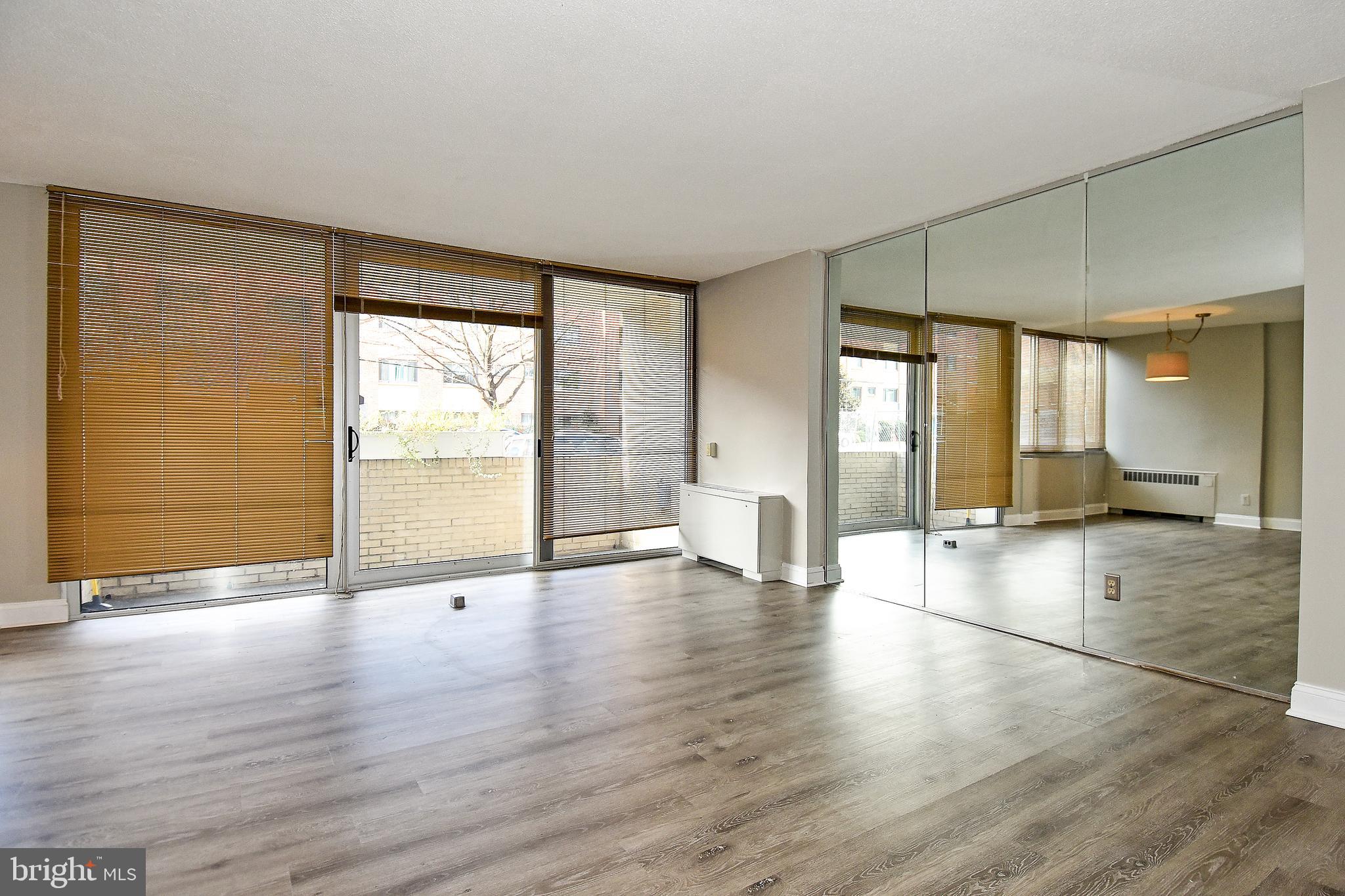 1301 South Arlington Ridge Road, Unit 110 Arlington, VA 22202 - Photo 15 of 45 a view of an empty room with window and wooden floor