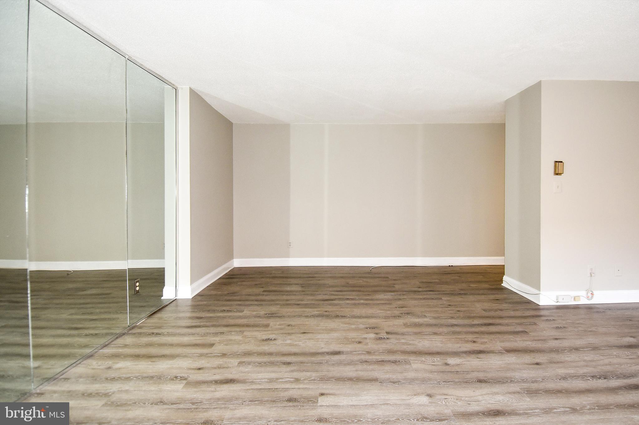 1301 South Arlington Ridge Road, Unit 110 Arlington, VA 22202 - Photo 17 of 45 a view of an empty room with wooden floor