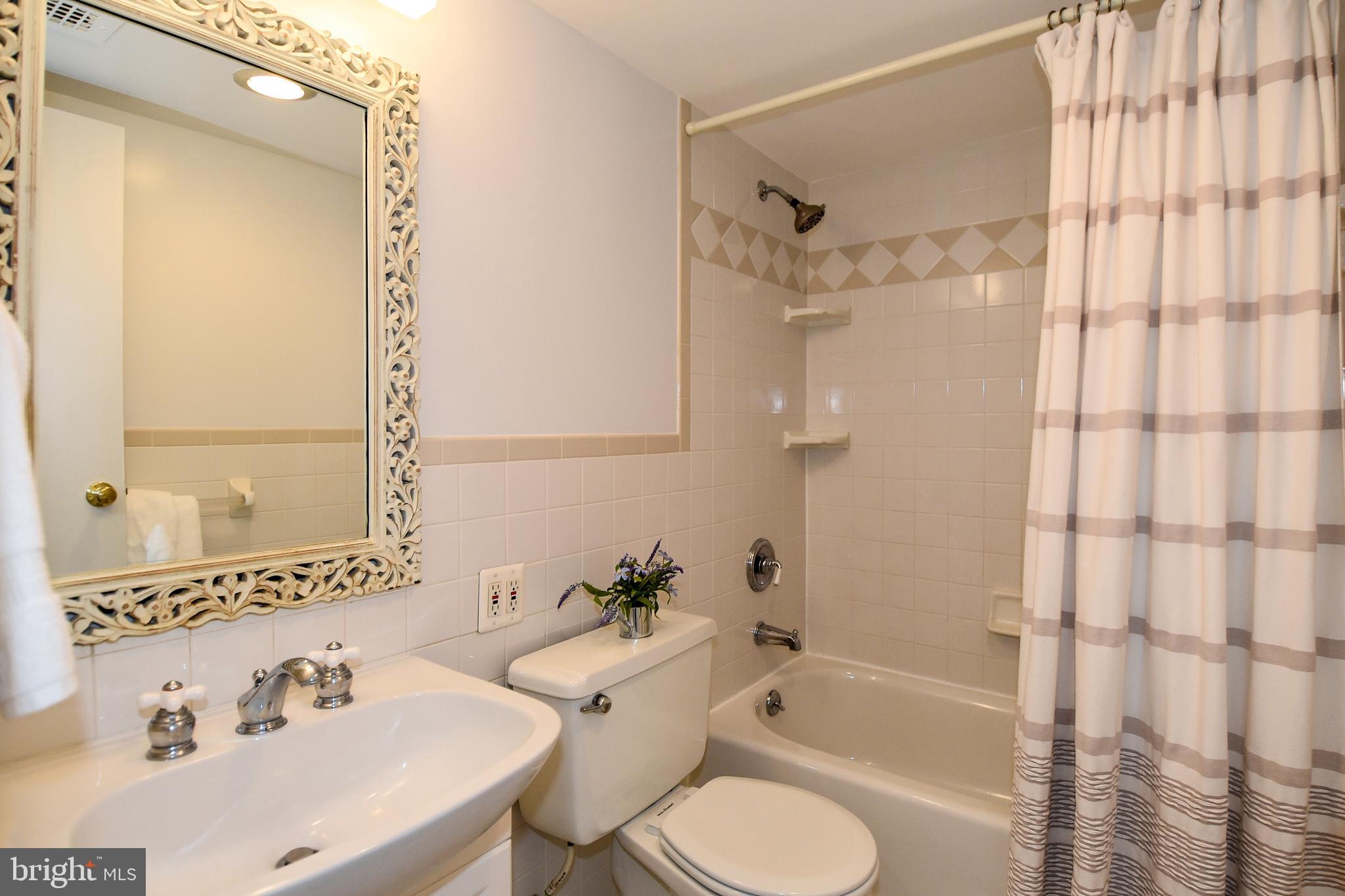 1301 South Arlington Ridge Road, Unit 110 Arlington, VA 22202 - Photo 21 of 45 a bathroom with a sink toilet and shower