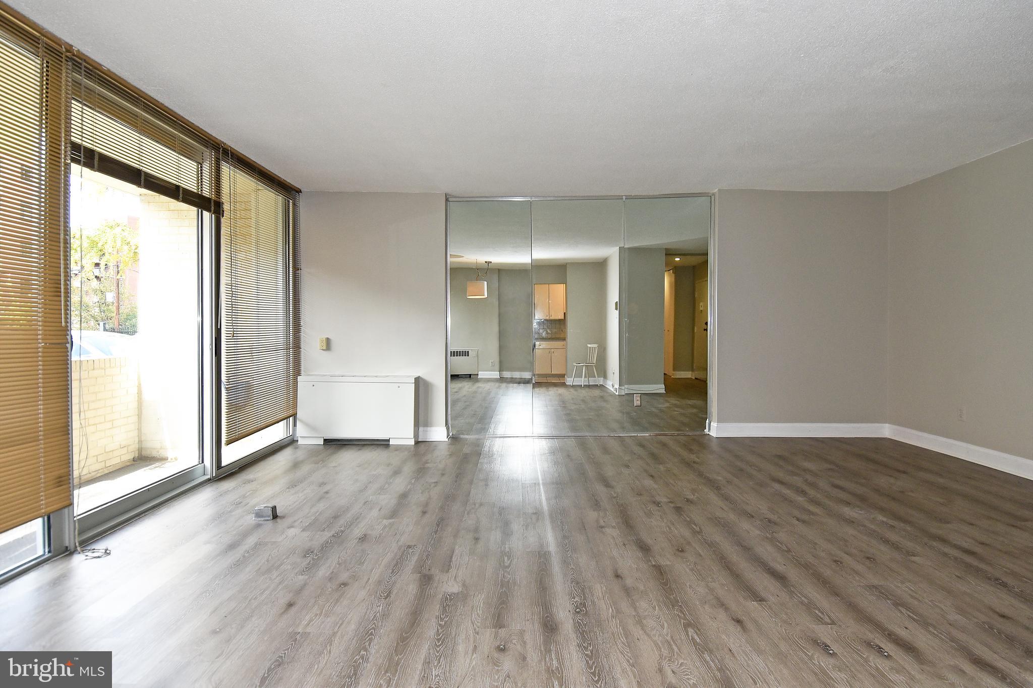 1301 South Arlington Ridge Road, Unit 110 Arlington, VA 22202 - Photo 4 of 45 a view of empty room with wooden floor and fan