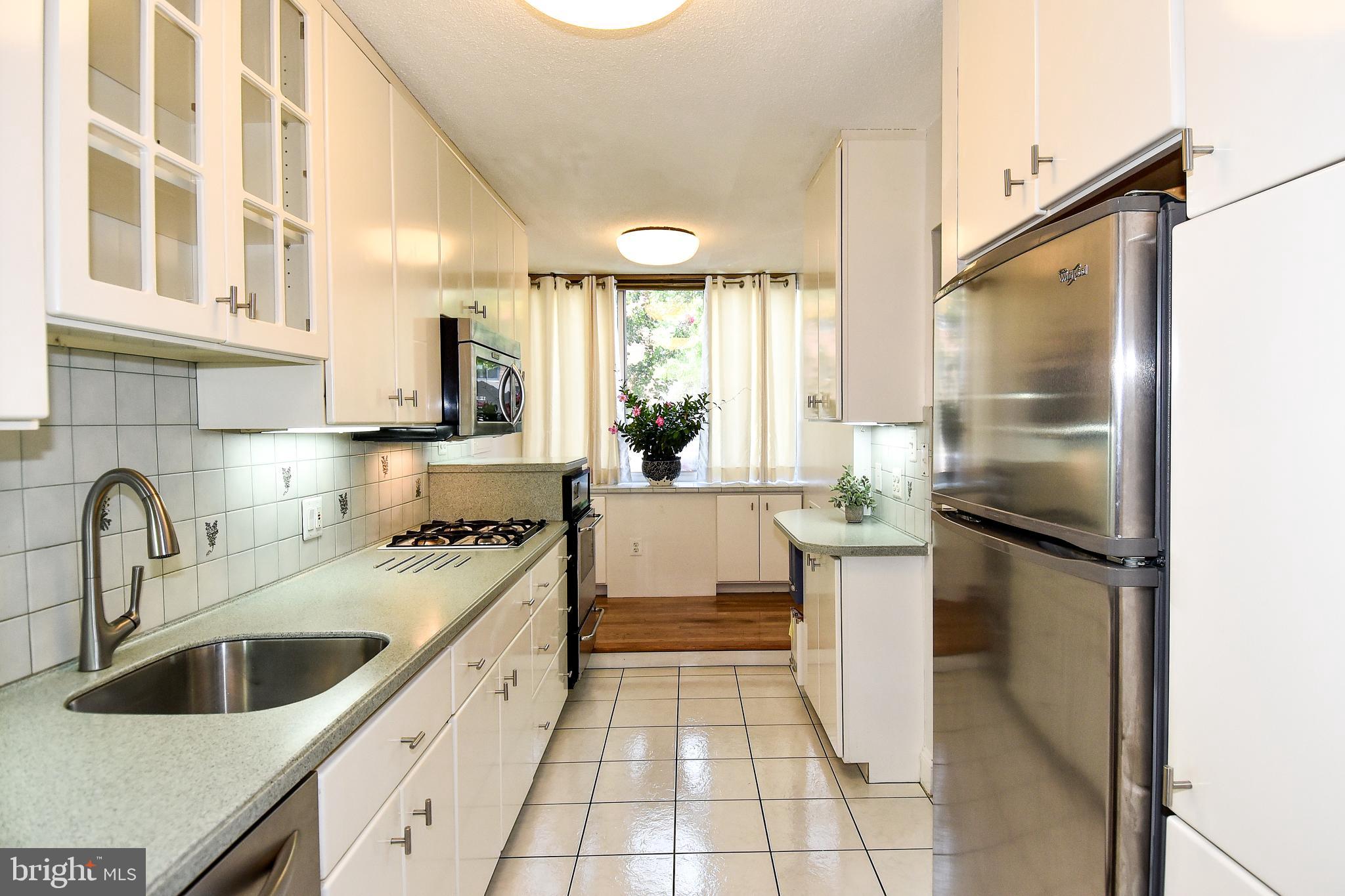 1301 South Arlington Ridge Road, Unit 110 Arlington, VA 22202 - Photo 6 of 45 a kitchen with a sink stove and refrigerator