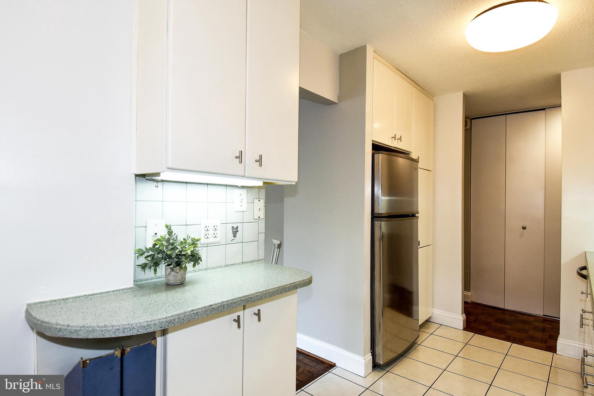 1301 South Arlington Ridge Road, Unit 110 Arlington, VA 22202 - Photo 10 of 45 a kitchen with stainless steel appliances granite countertop a sink and a refrigerator