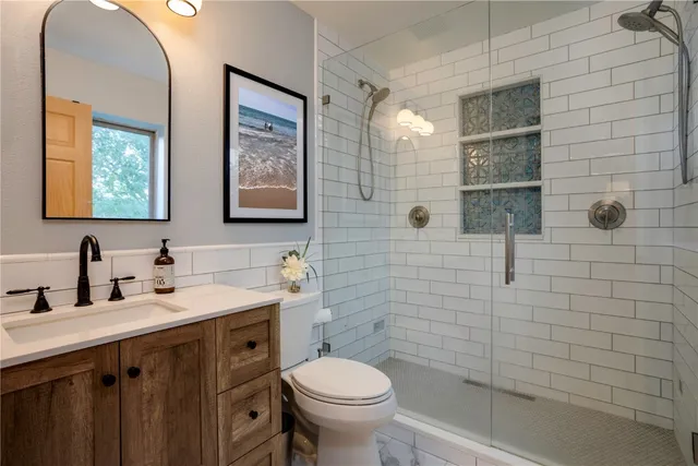 a bathroom with a toilet sink and mirror