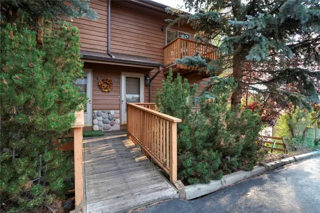 a view of a house with brick walls and wooden fence