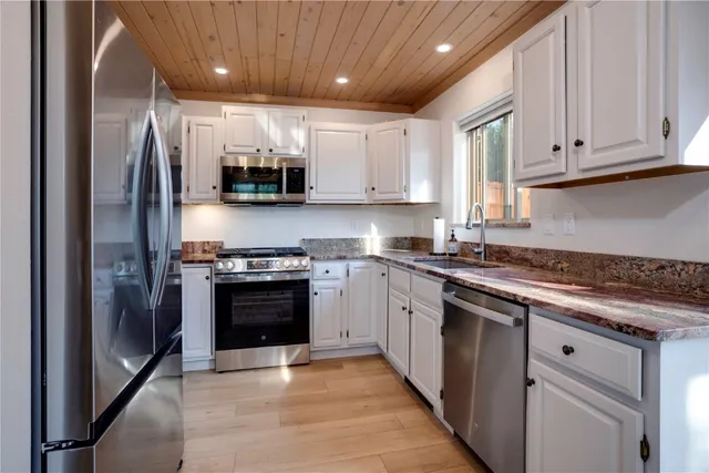 a kitchen with stainless steel appliances granite countertop a stove and a refrigerator