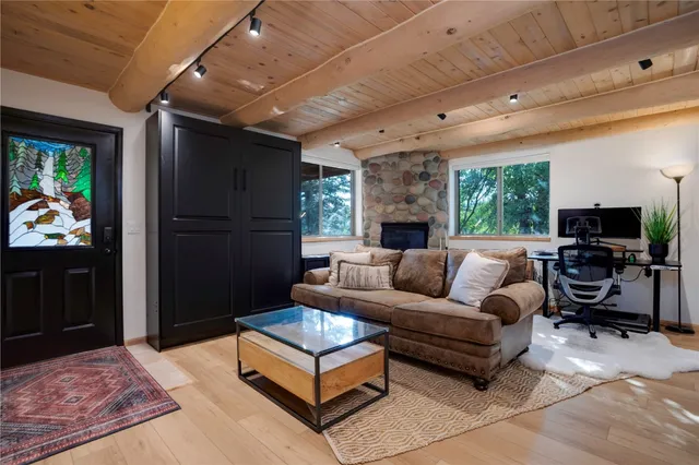 a living room with furniture a flat screen tv and a fireplace