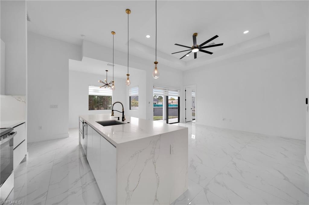 1138 Garibaldi Street East Lehigh Acres, FL 33974 - Photo 11 of 36 Kitchen featuring light marble finish floors, modern cabinets, white cabinetry, and recessed lighting