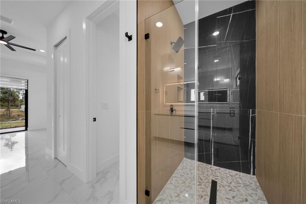 1138 Garibaldi Street East Lehigh Acres, FL 33974 - Photo 17 of 36 Bathroom with vanity, marble look tile flooring, a marble finish shower, a ceiling fan, and recessed lighting