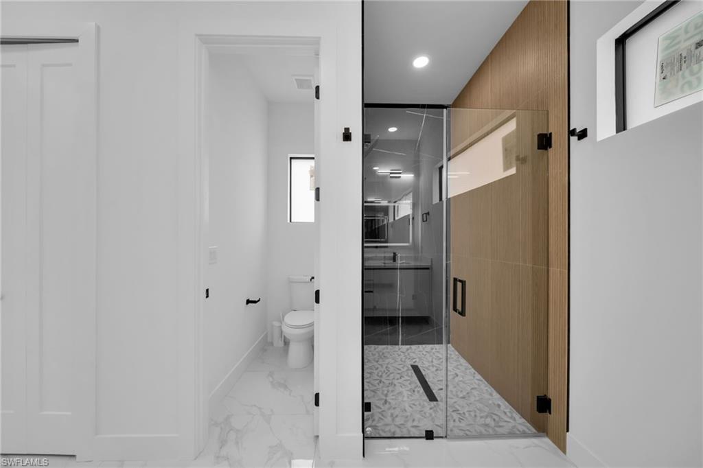 1138 Garibaldi Street East Lehigh Acres, FL 33974 - Photo 18 of 36 Full bath with a shower stall, light marble finish flooring, and recessed lighting